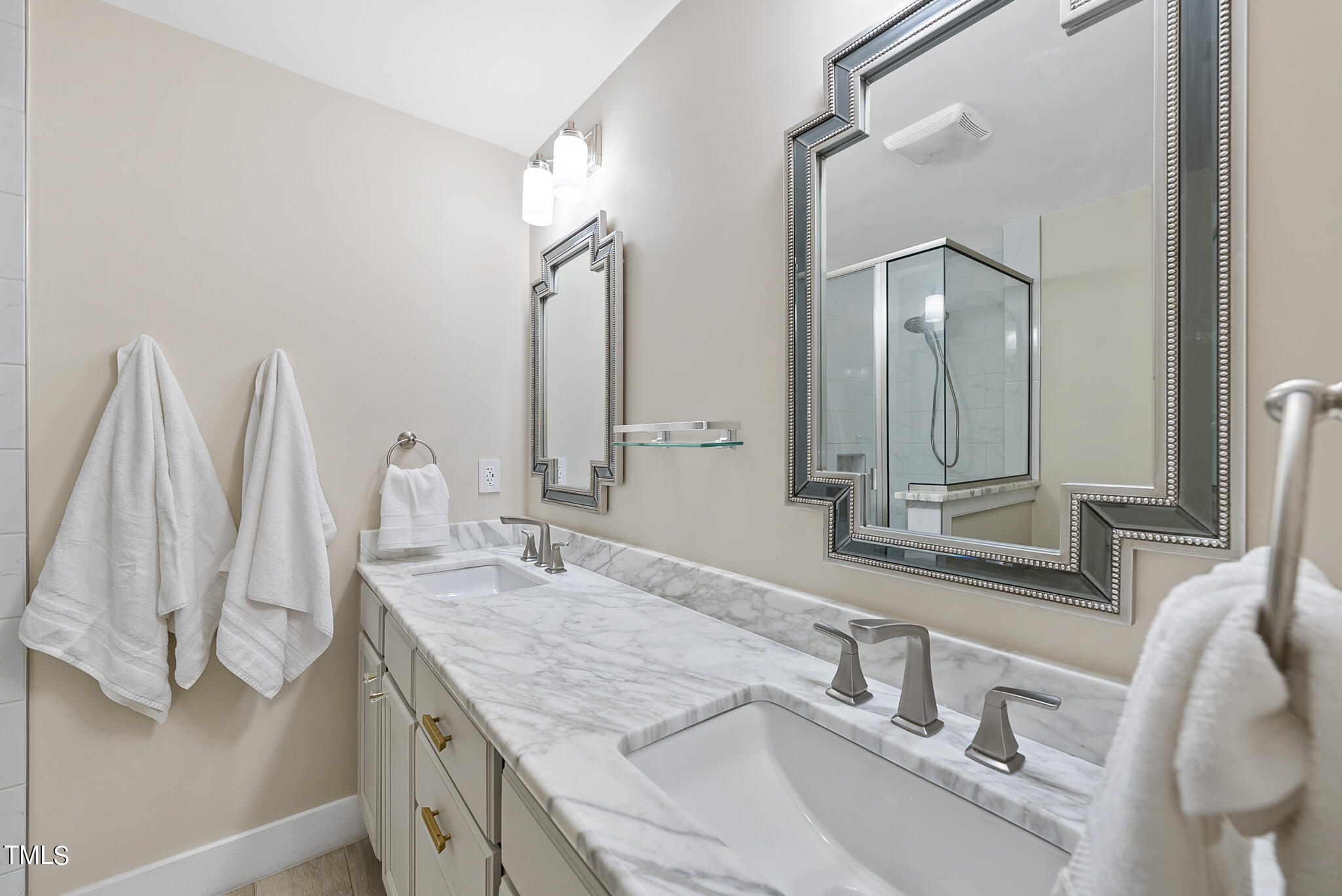 4900 Latimer Road Raleigh, NC 27609 - Photo 30 of 46 a bathroom with double vanity sink and a mirror