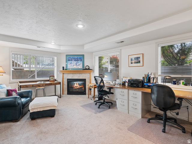 11881 Cottage View Lane Draper, UT 84020 - Photo 15 of 29 Living area featuring a gas fireplace with a stone surround and wood mantel, recessed lighting, and multiple windows with blinds