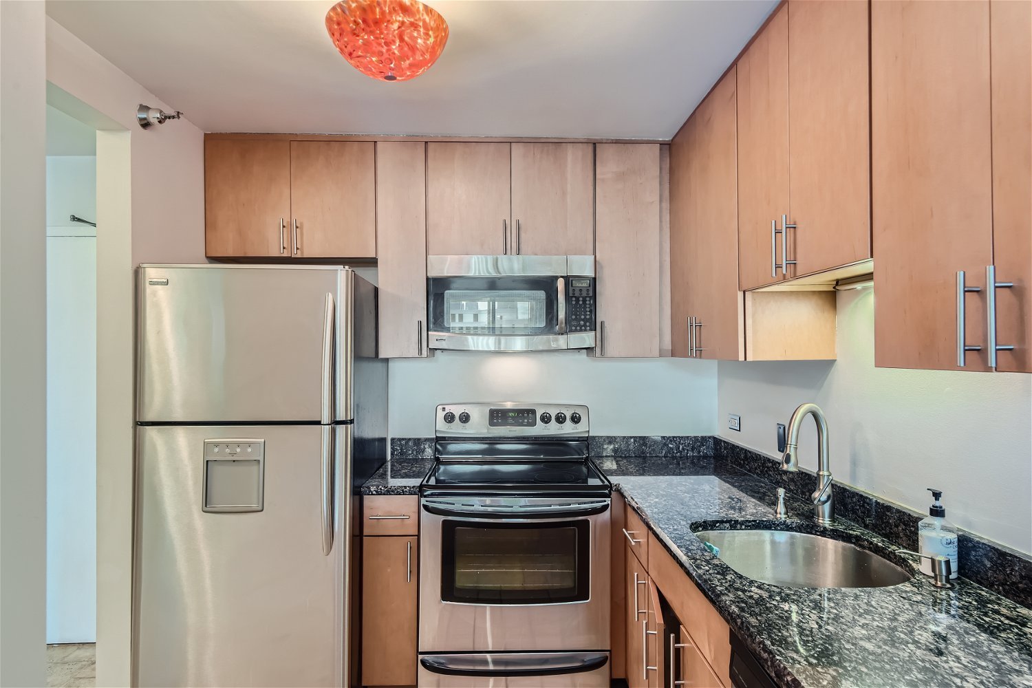 1212 North LaSalle Drive, Unit 1603 Chicago, IL 60610 - Photo 6 of 14 a kitchen with stainless steel appliances granite countertop a refrigerator stove and sink
