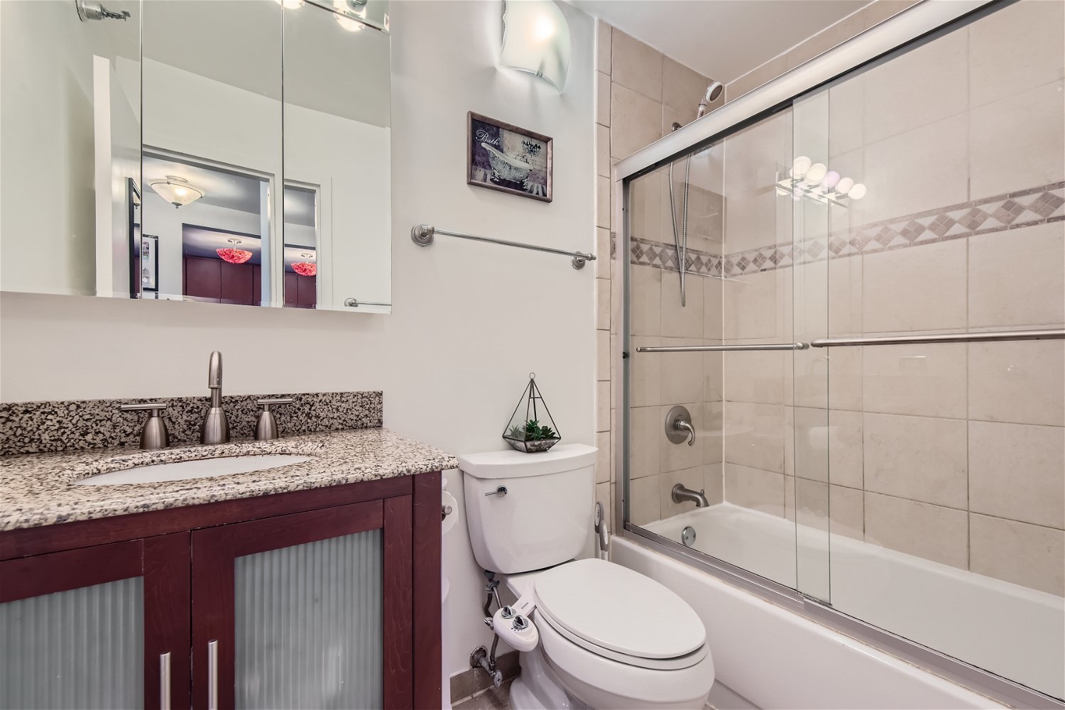 1212 North LaSalle Drive, Unit 1603 Chicago, IL 60610 - Photo 9 of 14 a bathroom with a sink a toilet and shower