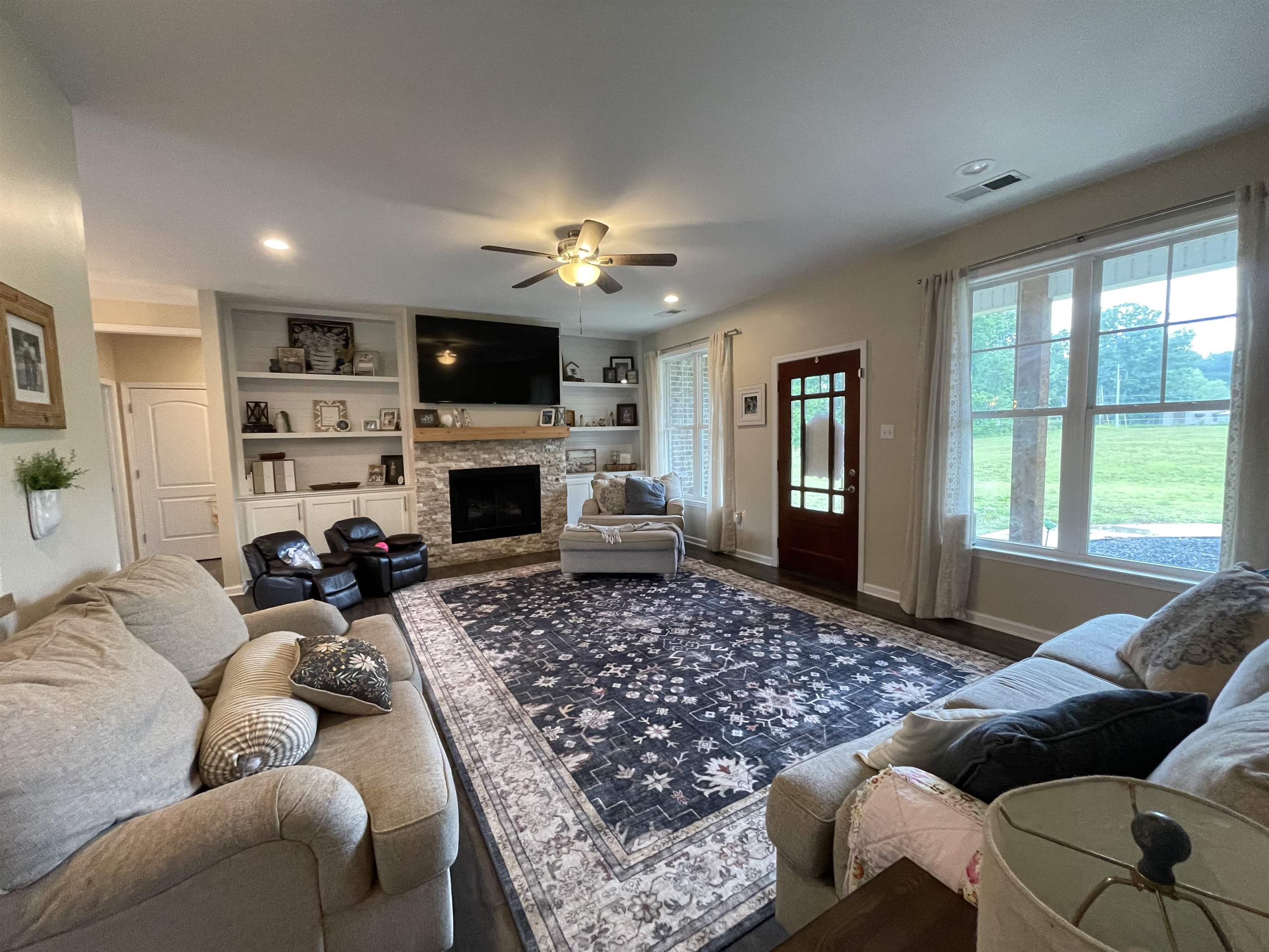 378 Holly Grove Road Covington, TN 38019 - Photo 3 of 23 a living room with furniture a flat screen tv and a fireplace