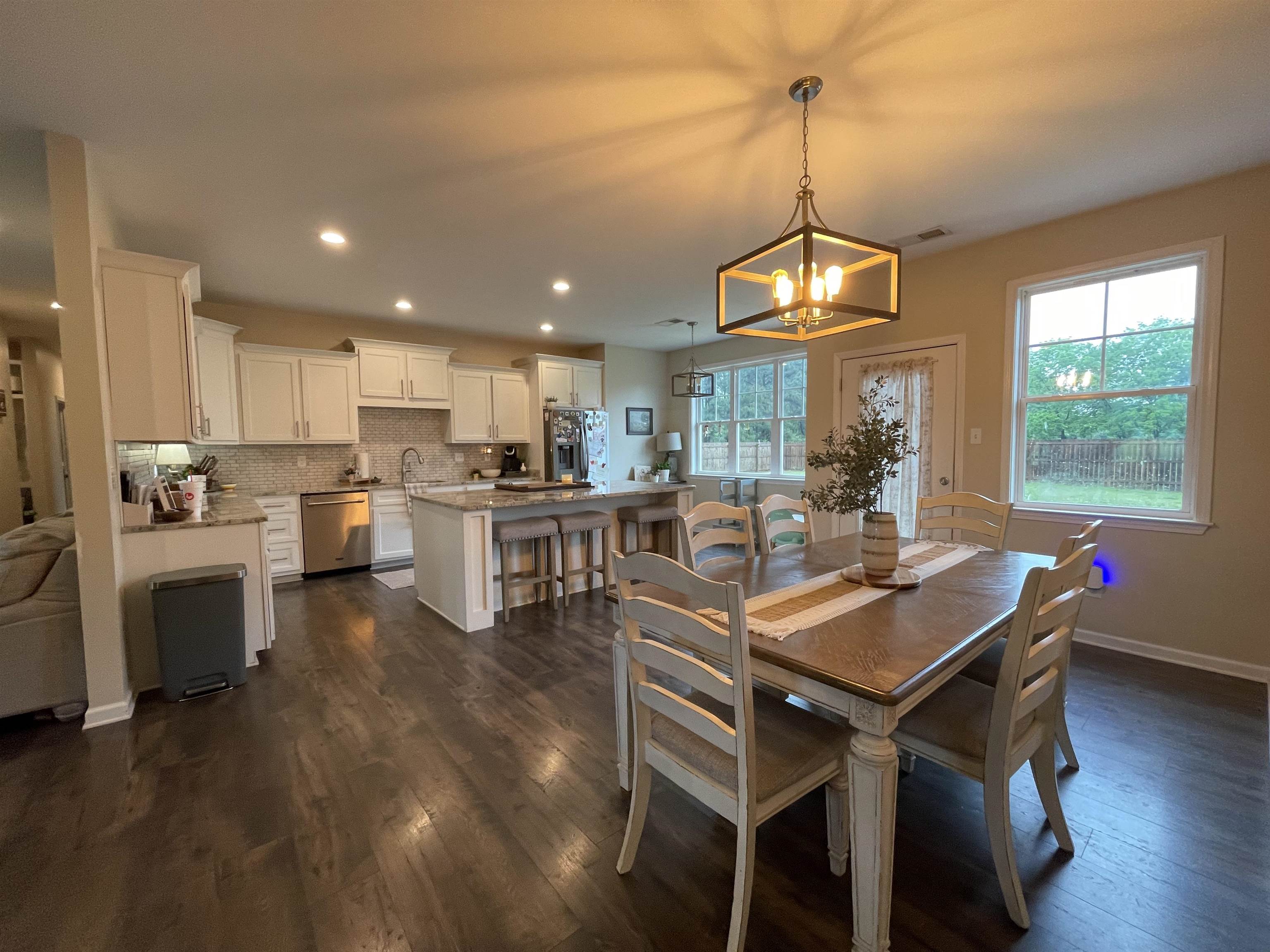 378 Holly Grove Road Covington, TN 38019 - Photo 8 of 23 a kitchen with a table chairs refrigerator and microwave