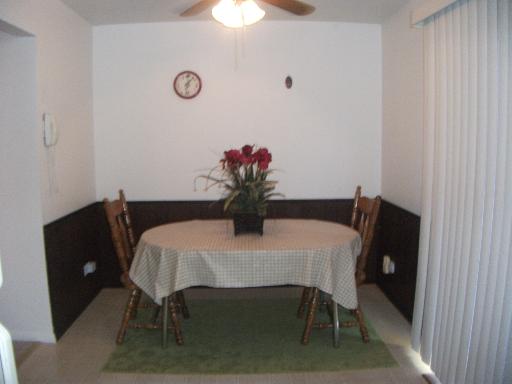 2089 Kettering Road Hoffman Estates, IL 60169 - Photo 8 of 14 a dining room with furniture and a potted plant