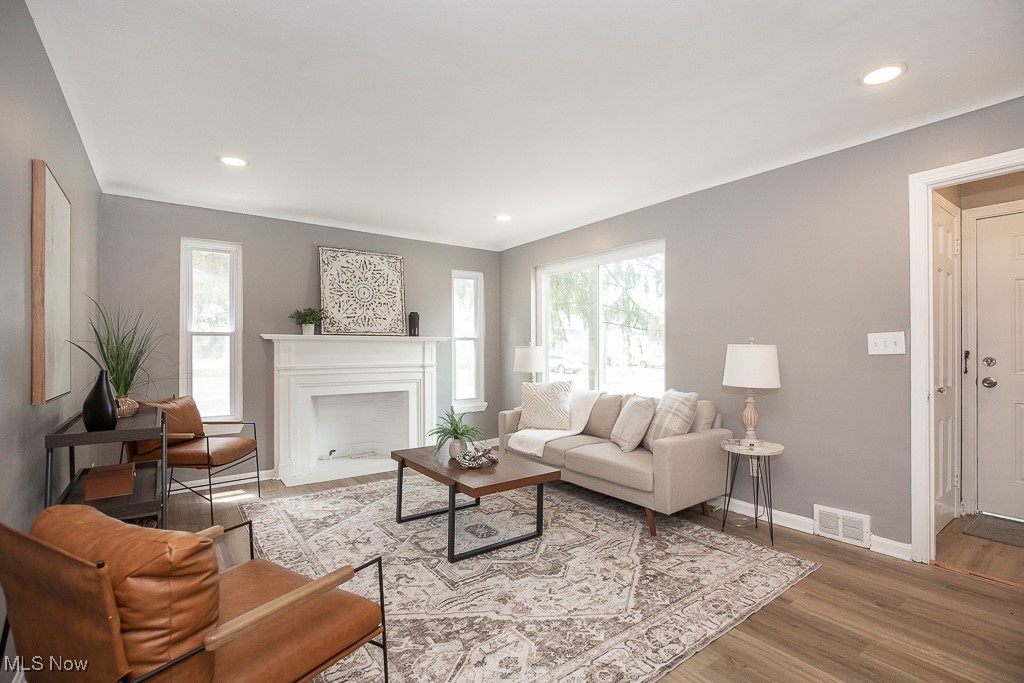 1547 Genesee Road South Euclid, OH 44121 - Photo 2 of 36 Living area featuring healthy amount of natural light, baseboards, wood finished floors, recessed lighting, and a fireplace with flush hearth