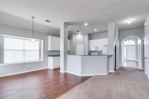 a view of a kitchen with a sink and a large window