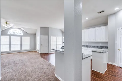 a view of a kitchen with an empty space and a window