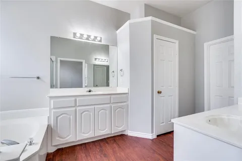 a spacious bathroom with a sink a mirror and a vanity