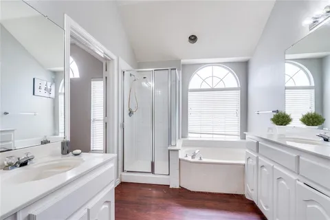 a bathroom with a bathtub a sink and a window