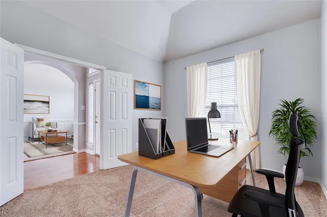 a living room with furniture a flat screen tv and a window