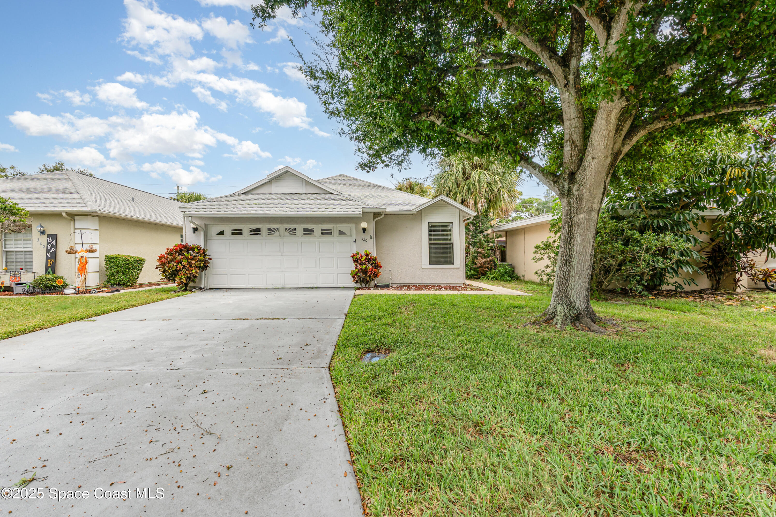 320 Myrtlewood Road Melbourne, FL 32940 - Photo 1 of 18 a front view of a house with garden