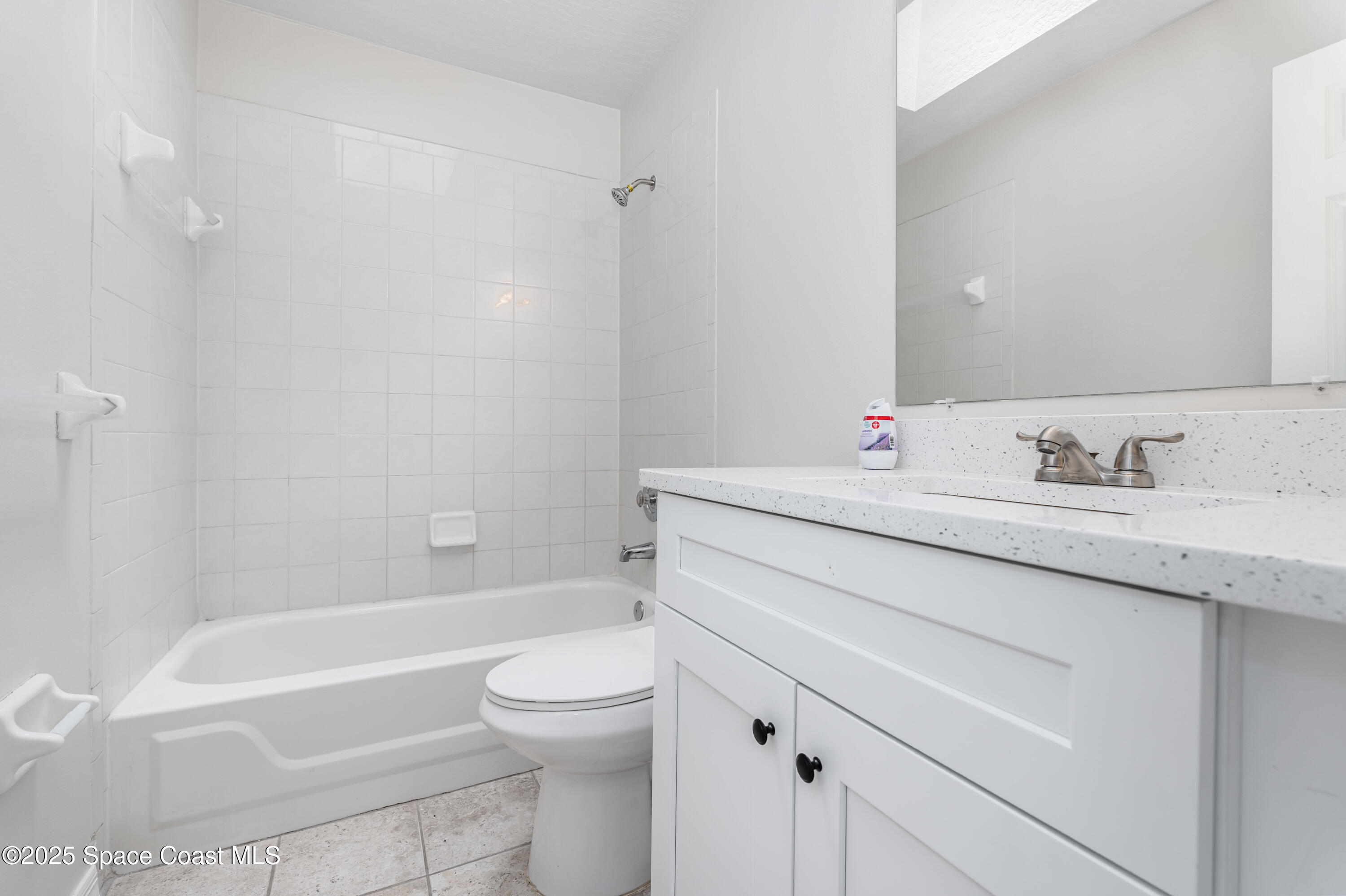 320 Myrtlewood Road Melbourne, FL 32940 - Photo 13 of 18 a bathroom with a granite countertop sink a toilet and bathtub