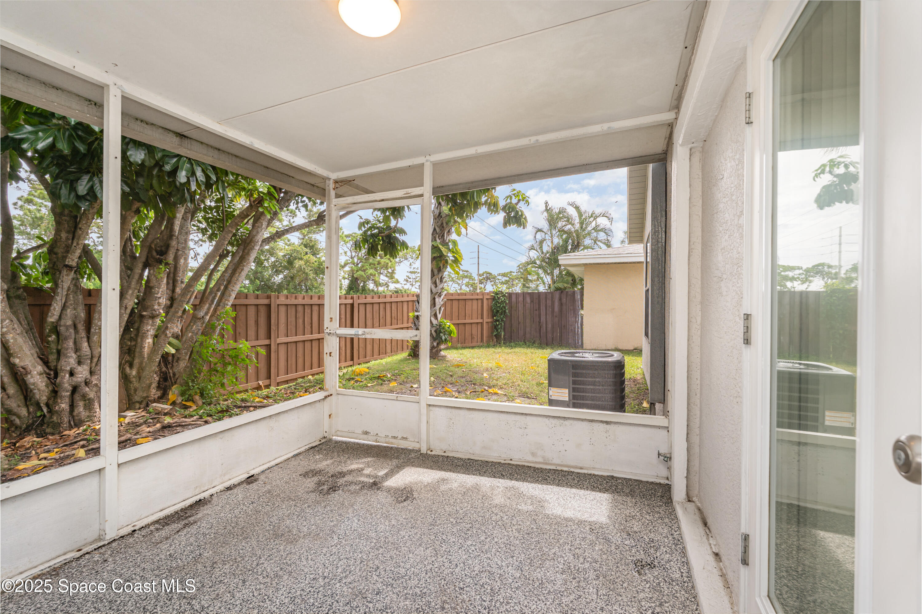 320 Myrtlewood Road Melbourne, FL 32940 - Photo 15 of 18 a view of an empty room with wooden floor and a large window
