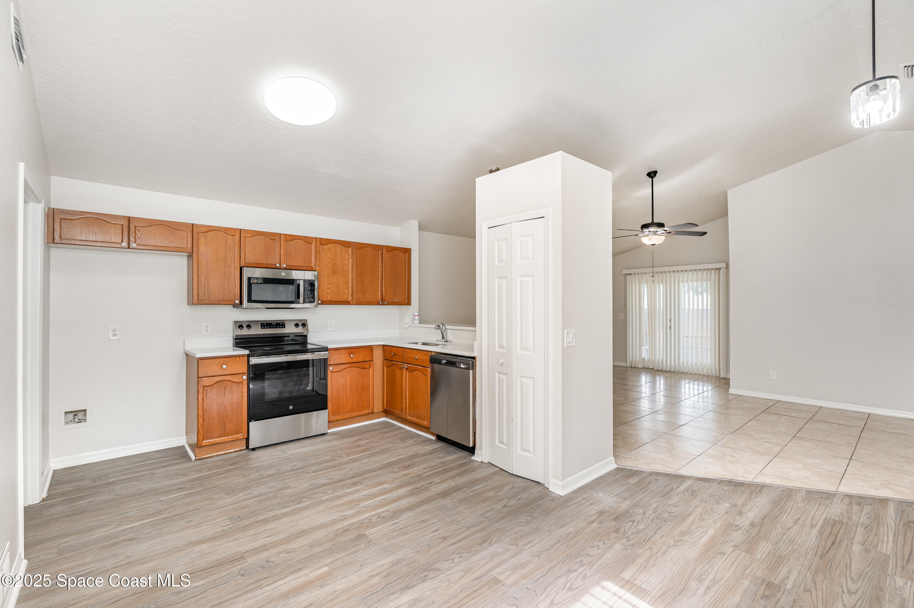 320 Myrtlewood Road Melbourne, FL 32940 - Photo 5 of 18 a kitchen with granite countertop a refrigerator and a stove top oven