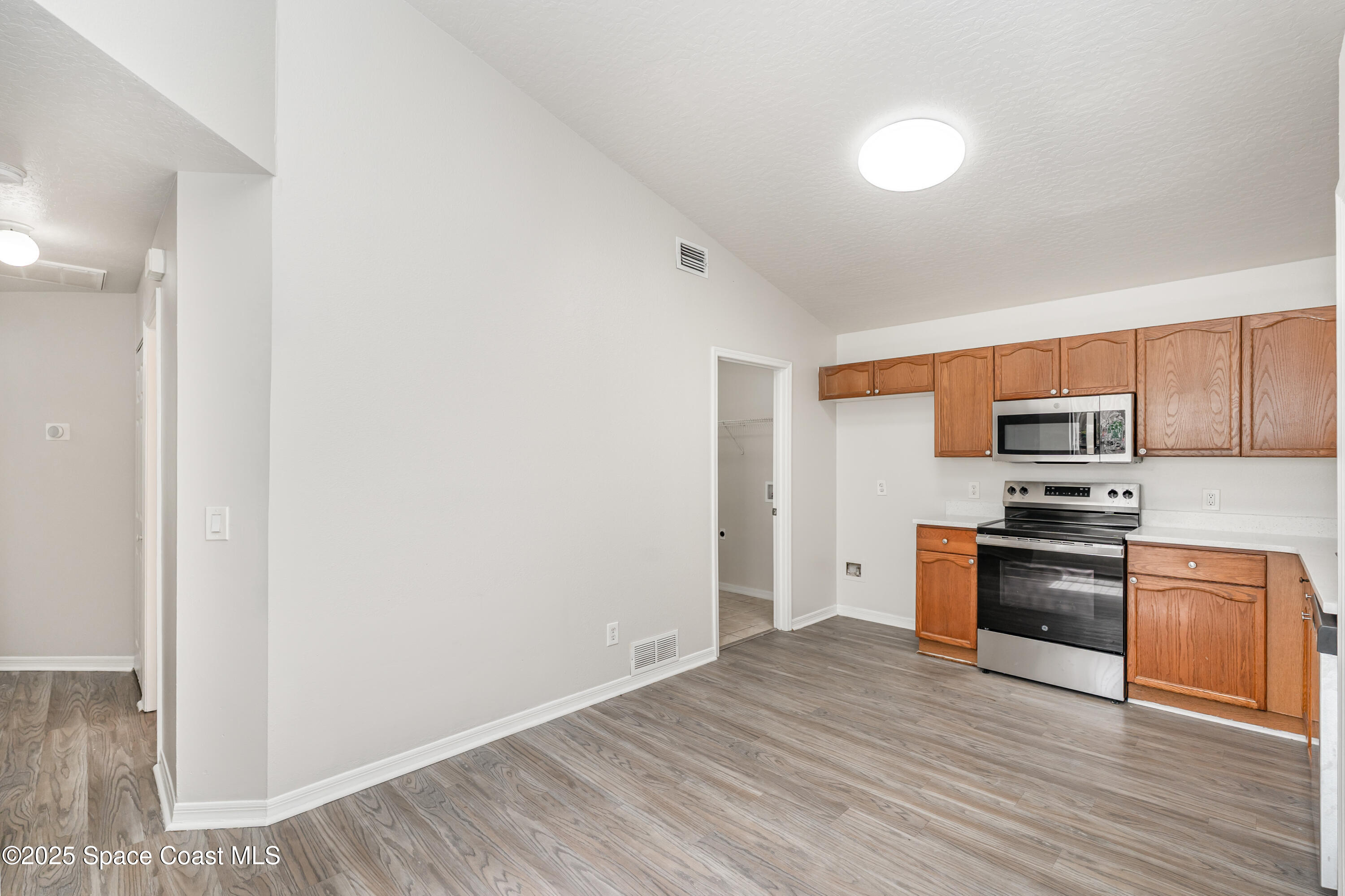 320 Myrtlewood Road Melbourne, FL 32940 - Photo 6 of 18 a kitchen with stainless steel appliances granite countertop a refrigerator and a stove top oven