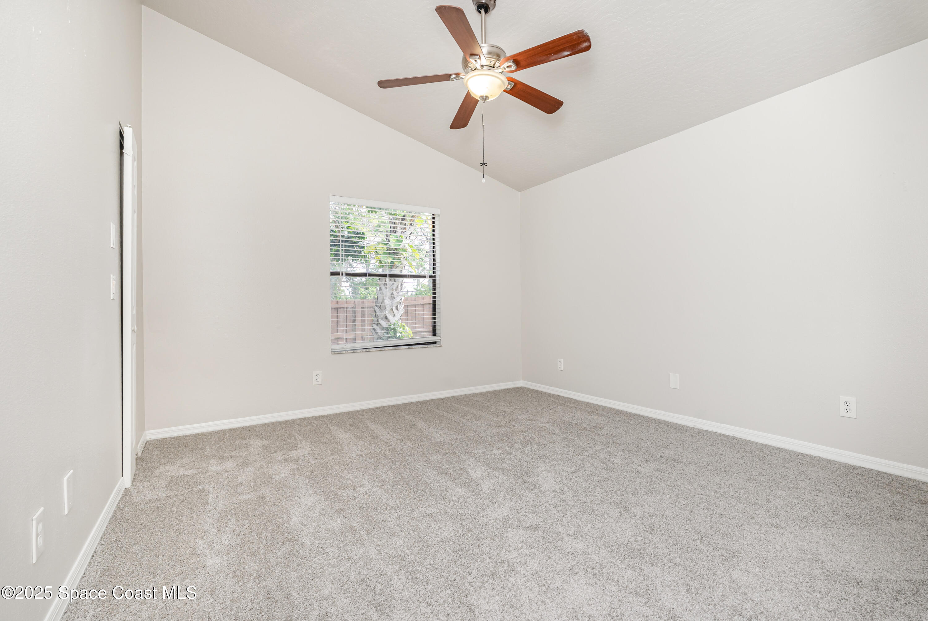 320 Myrtlewood Road Melbourne, FL 32940 - Photo 7 of 18 an empty room with a window and a fan