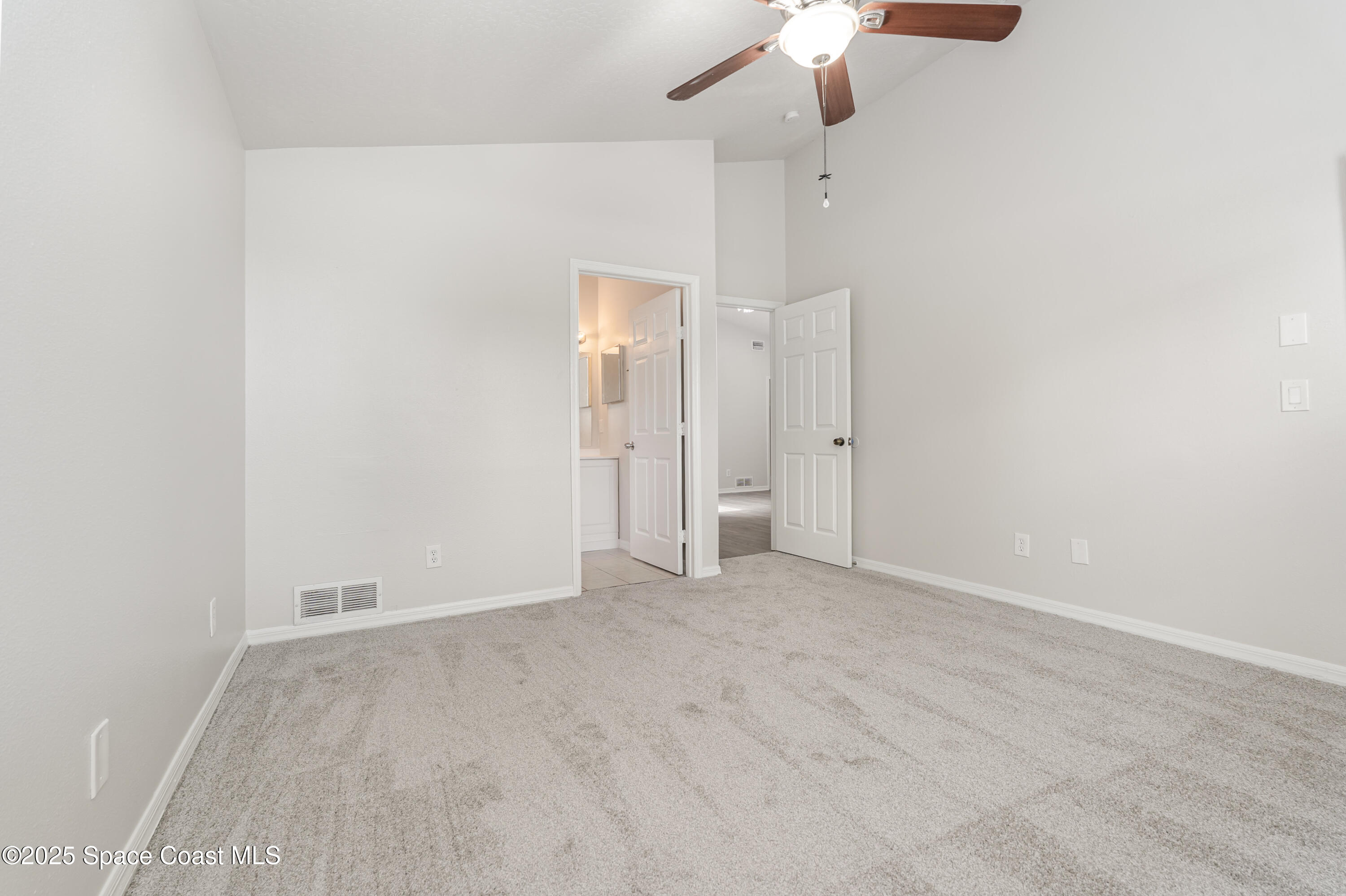 320 Myrtlewood Road Melbourne, FL 32940 - Photo 8 of 18 an empty room with a ceiling fan and a window