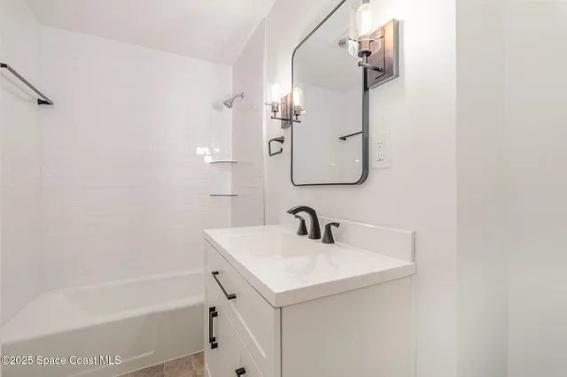 a bathroom with a sink a mirror and a bathtub