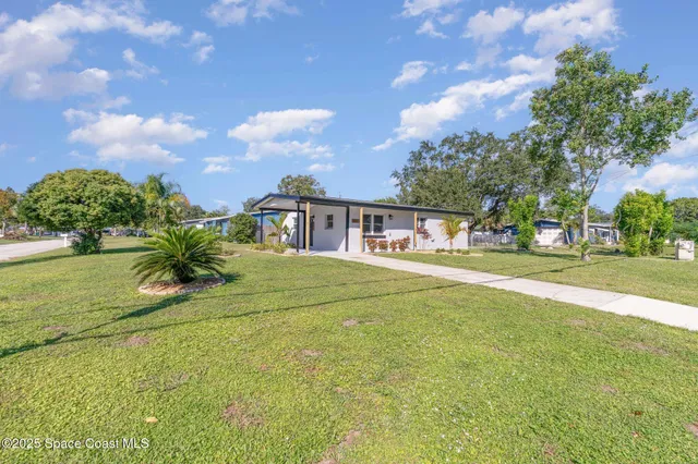 a house view with swimming pool and garden space