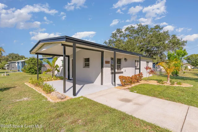 a view of a house with backyard porch and sitting area