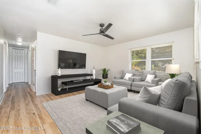 a living room with furniture and a flat screen tv