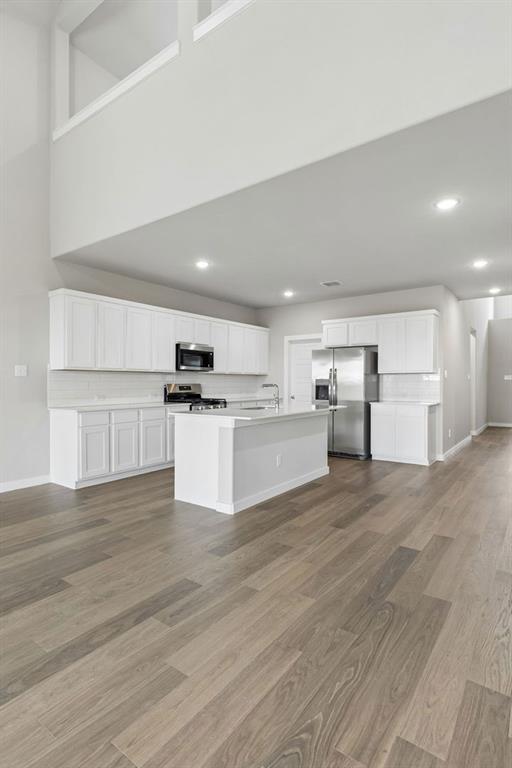 1121 Del Rio Drive Lavon, TX 75166 - Photo 6 of 32 a view of kitchen with wooden floor and electronic appliances