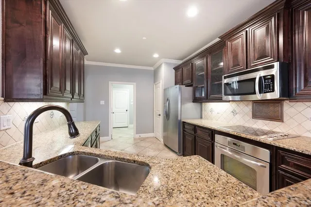 a kitchen with stainless steel appliances kitchen island granite countertop a sink and cabinets