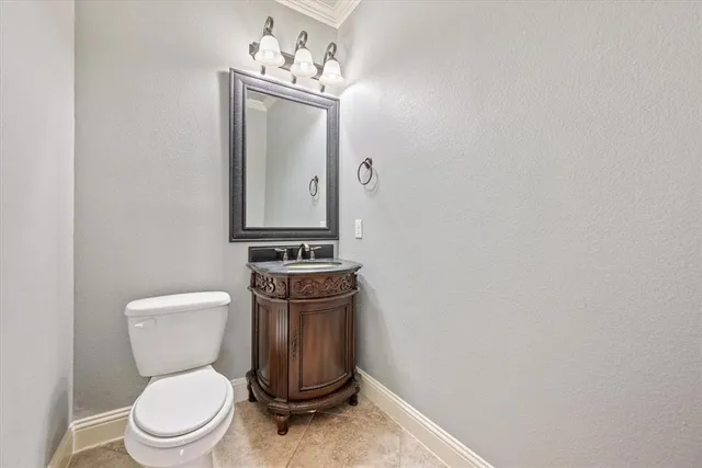 a white toilet sitting next to a bathroom sink
