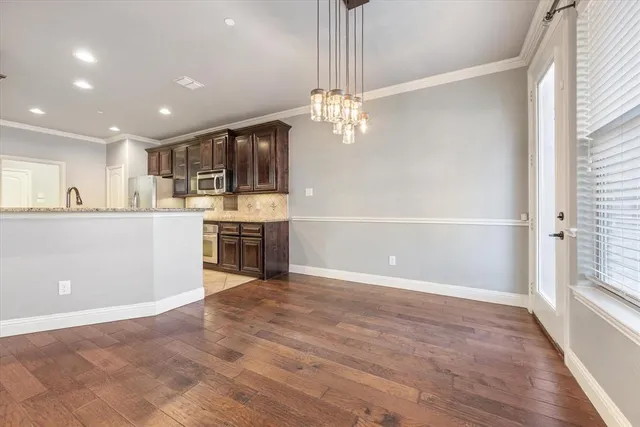 a view of a kitchen with a sink cabinets and wooden floor