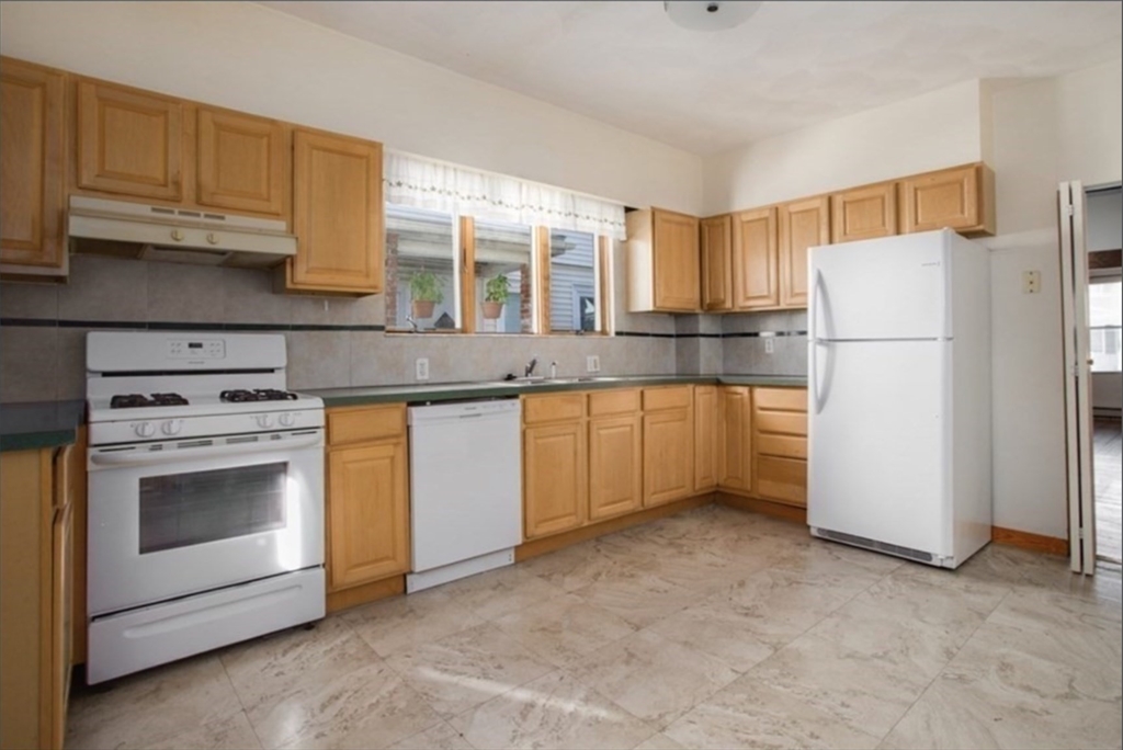 a kitchen with a stove a sink and a refrigerator