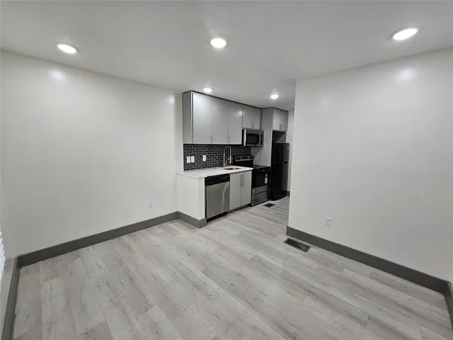 a view of kitchen with sink and microwave