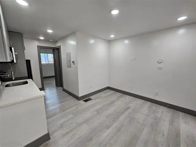 a view of hallway with stairs and wooden floor