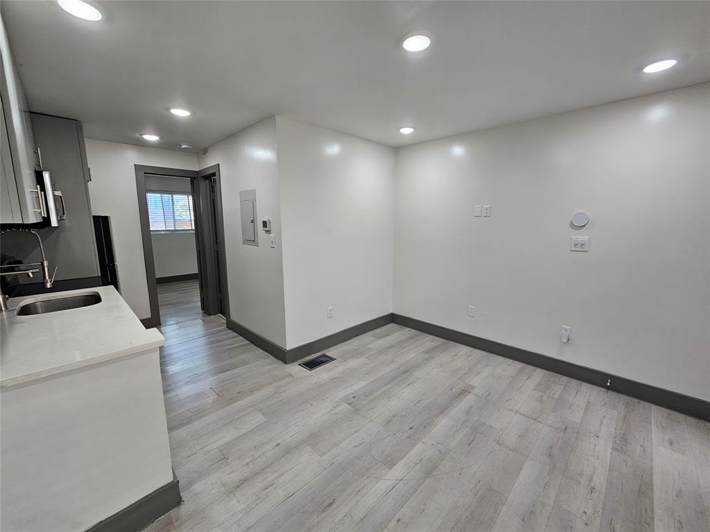 4806 Virginia Avenue, Unit 108 Dallas, TX 75204 - Photo 4 of 9 a view of hallway with stairs and wooden floor