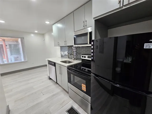a kitchen with a refrigerator stove and microwave