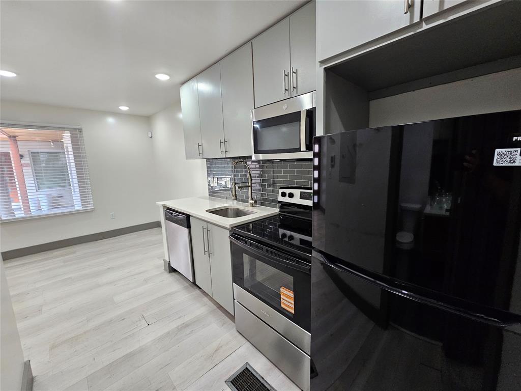4806 Virginia Avenue, Unit 108 Dallas, TX 75204 - Photo 6 of 9 a kitchen with a refrigerator stove and microwave