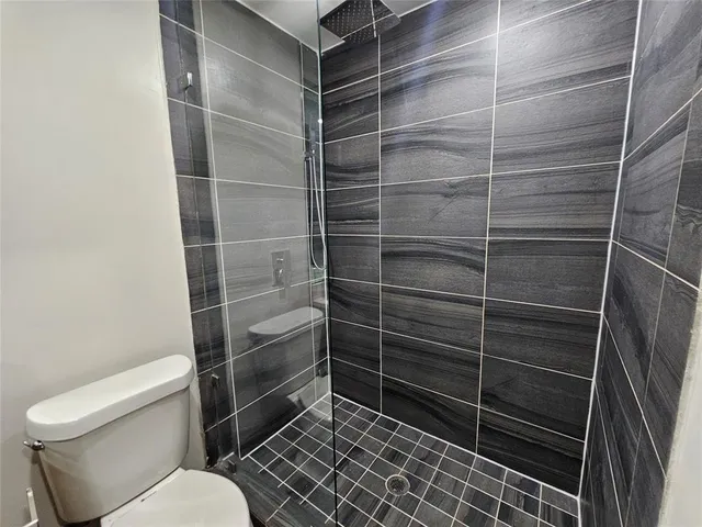 a bathroom with a toilet and a shower