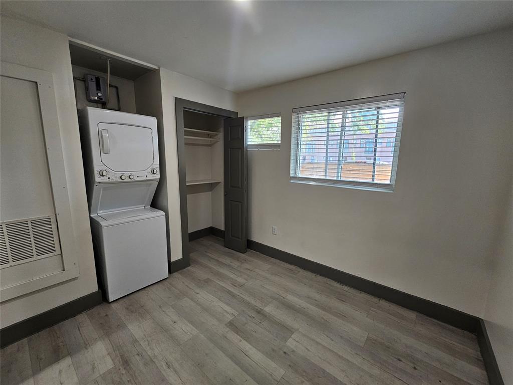4806 Virginia Avenue, Unit 108 Dallas, TX 75204 - Photo 9 of 9 wooden floor in an empty room with a window