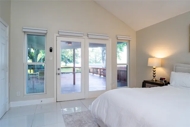 a bedroom with a bed and a lamp