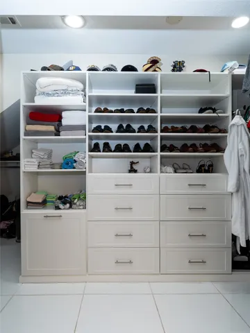 a kitchen with white cabinets and appliances