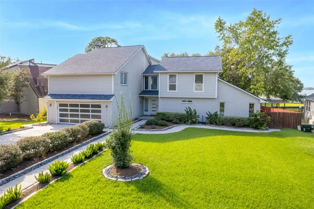a front view of house with yard and outdoor seating