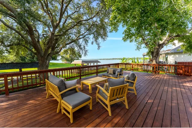 a view of a roof deck with wooden floor and fence