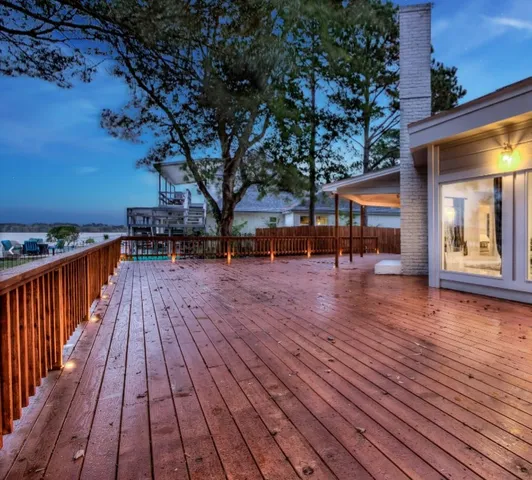 a view of outdoor space with wooden floor and trees