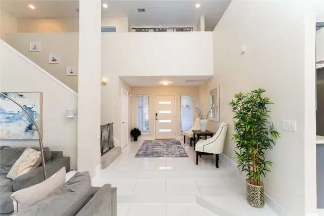 a living room with furniture and a potted plant