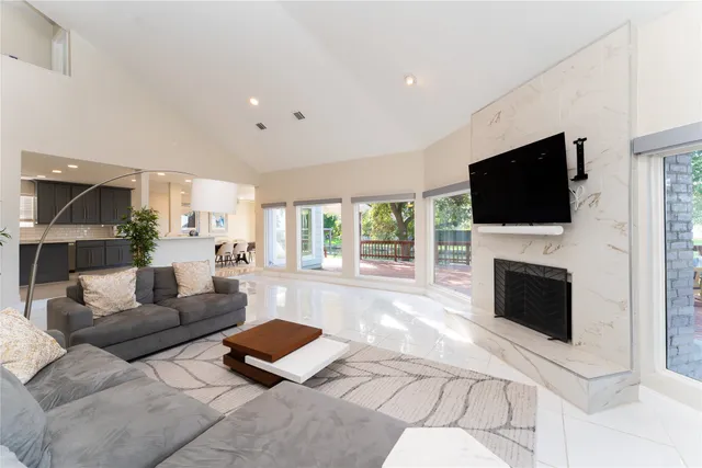 a living room with furniture a fireplace and a flat screen tv