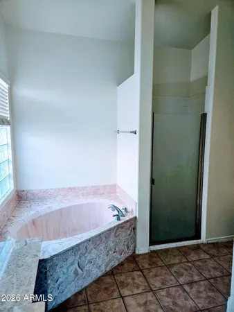 a bathroom with bathtub and shower