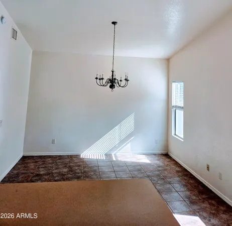 a view of a room with a ceiling fan and window