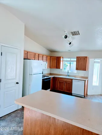 a kitchen with stainless steel appliances granite countertop a refrigerator and a stove