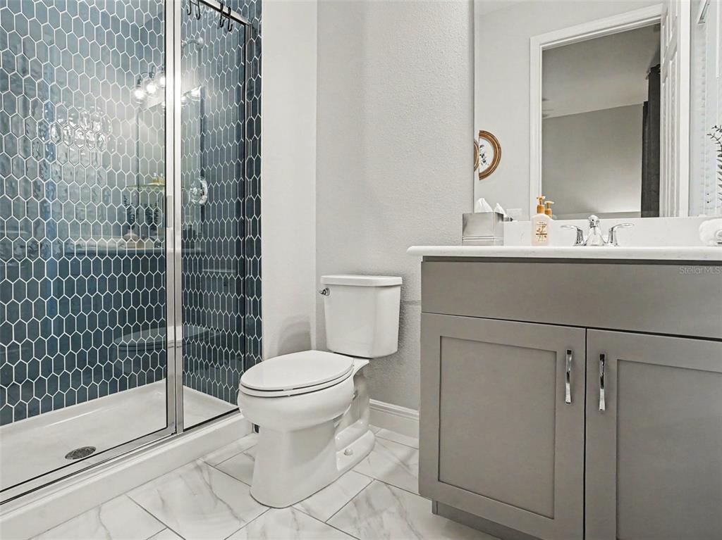 5270 Obsidian Gate Road Mount Dora, FL 32757 - Photo 23 of 50 a bathroom with a toilet sink and shower