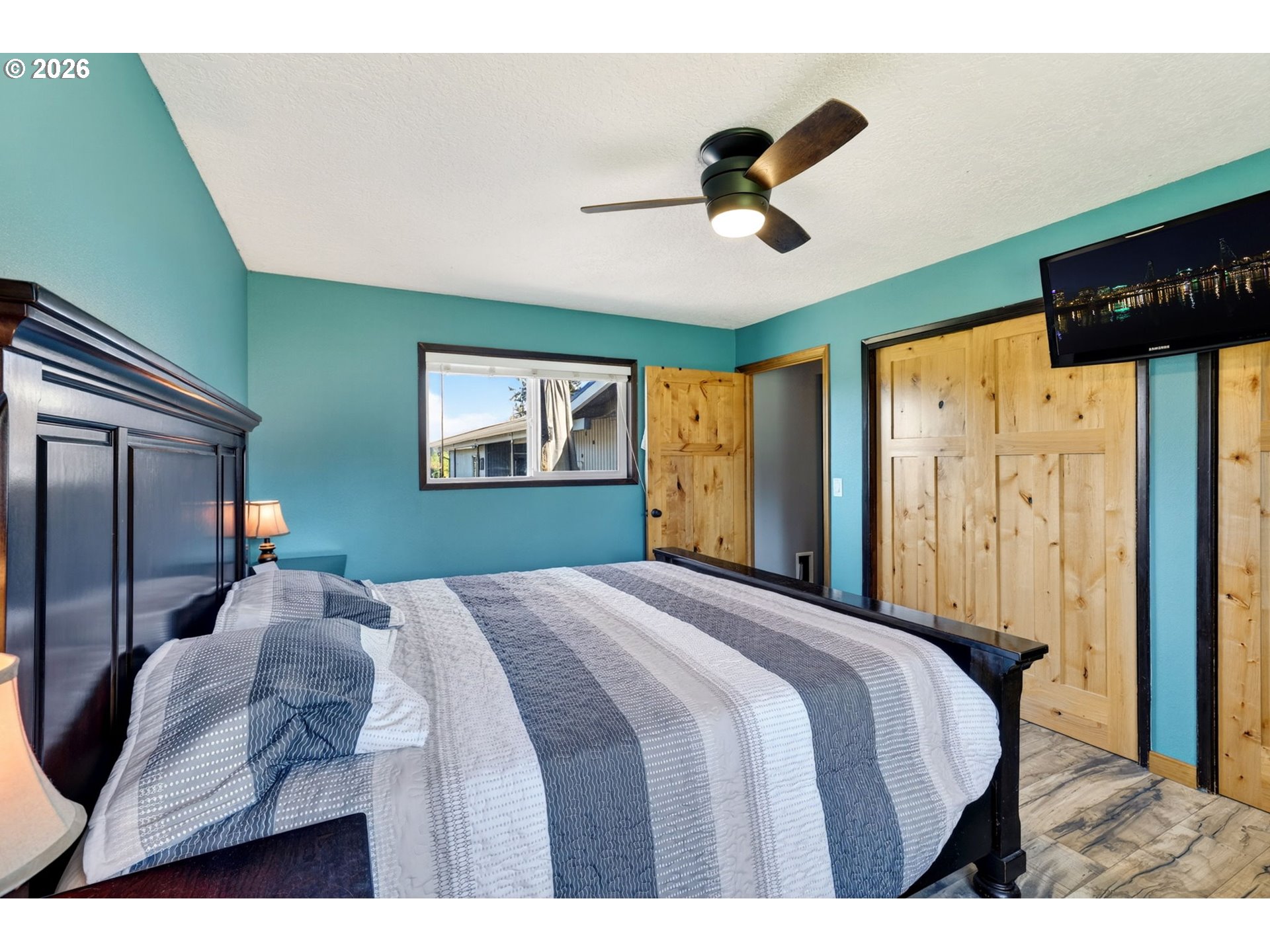 17623 South Windy City Road Mulino, OR 97042 - Photo 16 of 48 a bedroom with a large bed and a chandelier