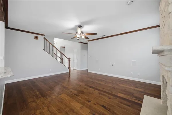 a view of a room with wooden floor