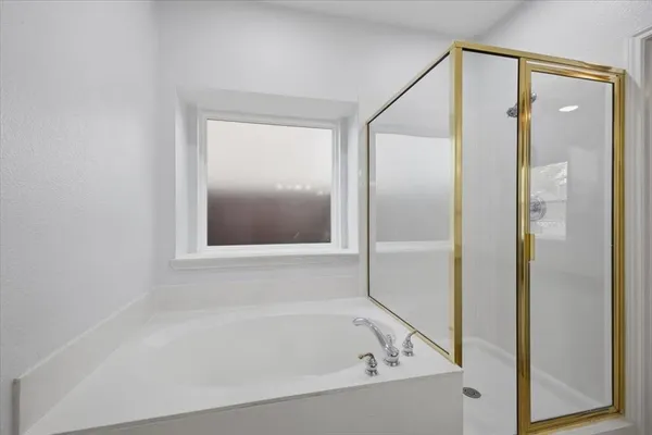 a bathroom with a bathtub and a shower